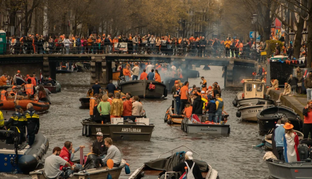 Amsterdam canals filled with boats during King's Day Canal Parade