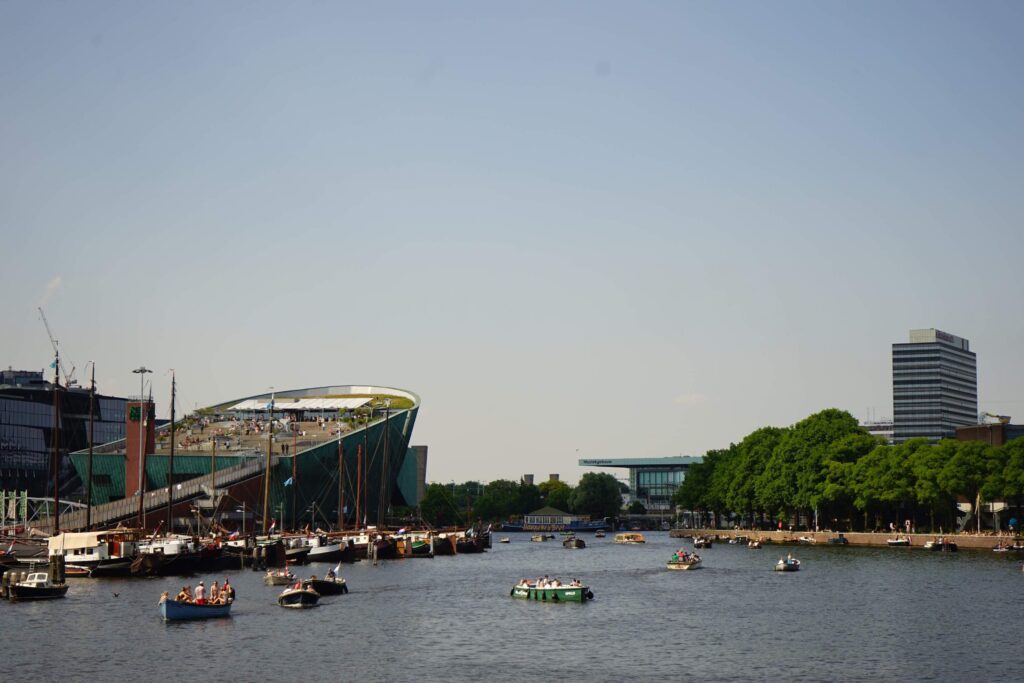 Summer in Amsterdam with a picture of people in boats