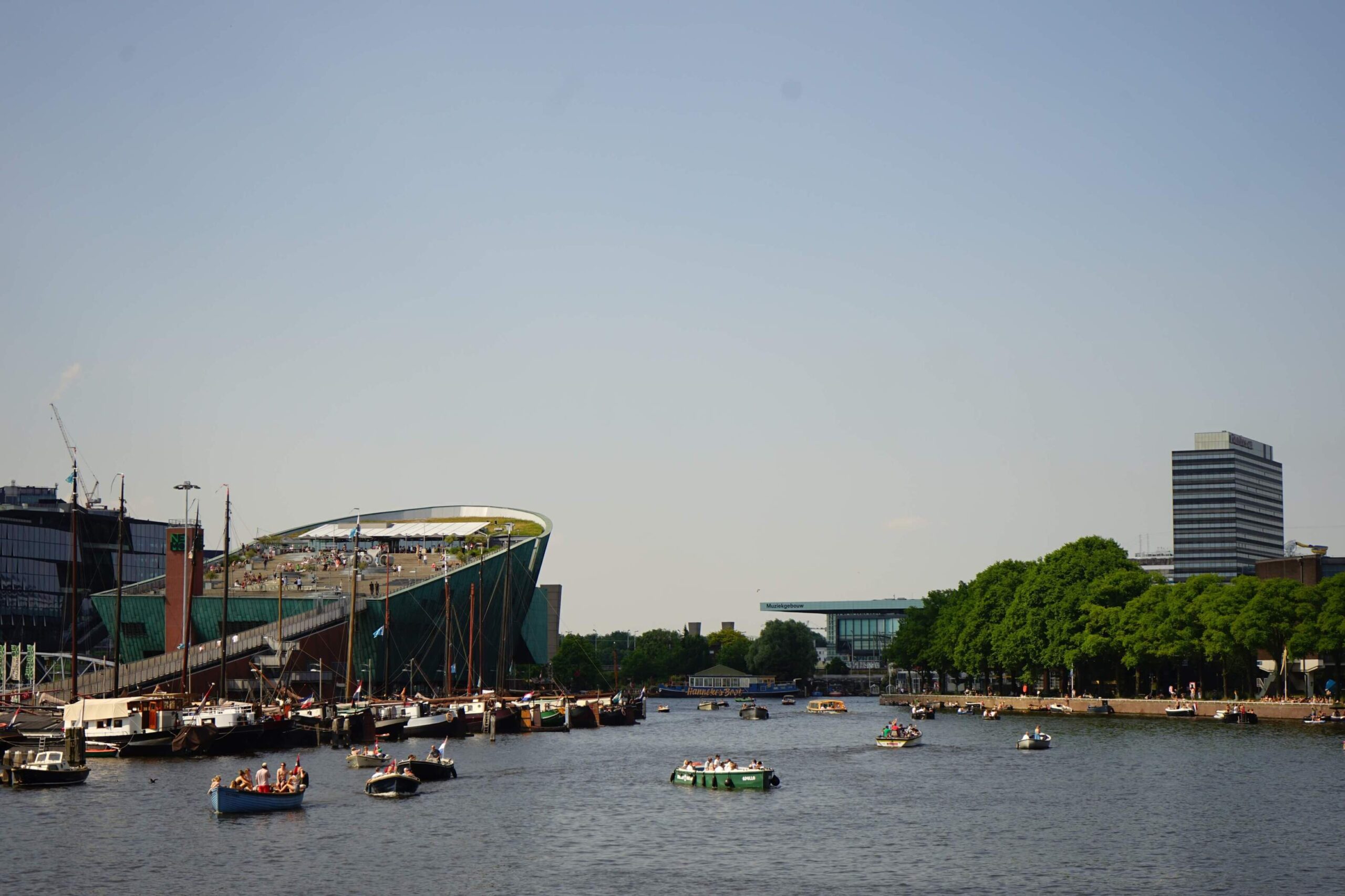 Summer in Amsterdam with a picture of people in boats